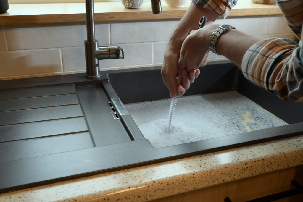 Blocked sink being cleared in a Kent home